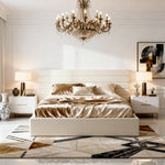 Modern bedroom with a chandelier, bed, and side tables.