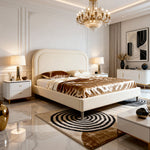 Luxurious bedroom with a large bed, chandelier, and decorative elements.