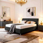 Modern bedroom with a gray upholstered bed, nightstands, and decorative elements.