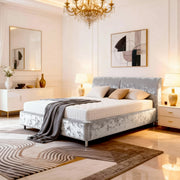 Luxurious bedroom with a bed, chandelier, and decorative elements.