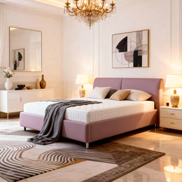 Modern bedroom with a pink bed, chandelier, and abstract art.