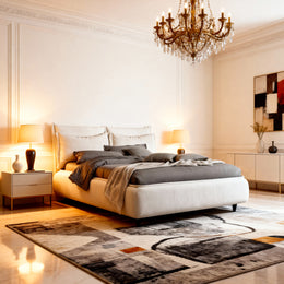 Modern bedroom with a large bed, chandelier, and decorative rug.